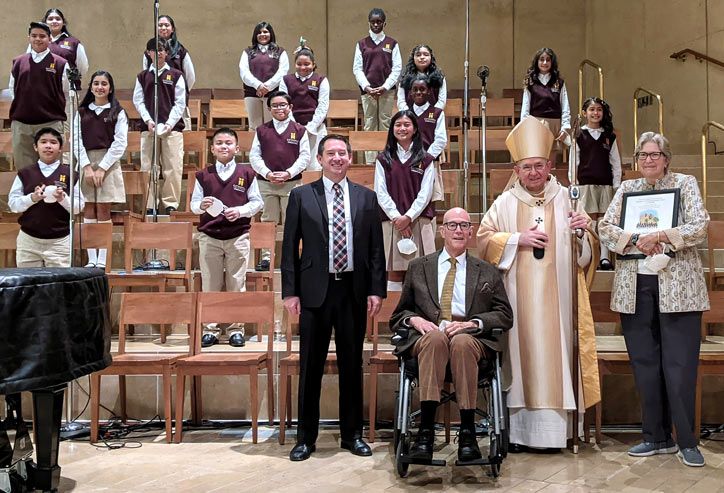 Richard and Maria Grant with the children's choir at Our Lady QUeen of the Angels Cathedral.